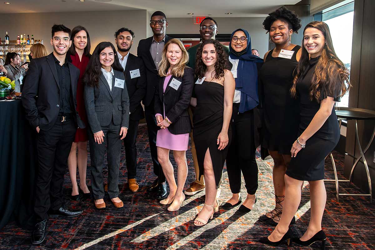 Suzanne poses with a group of students