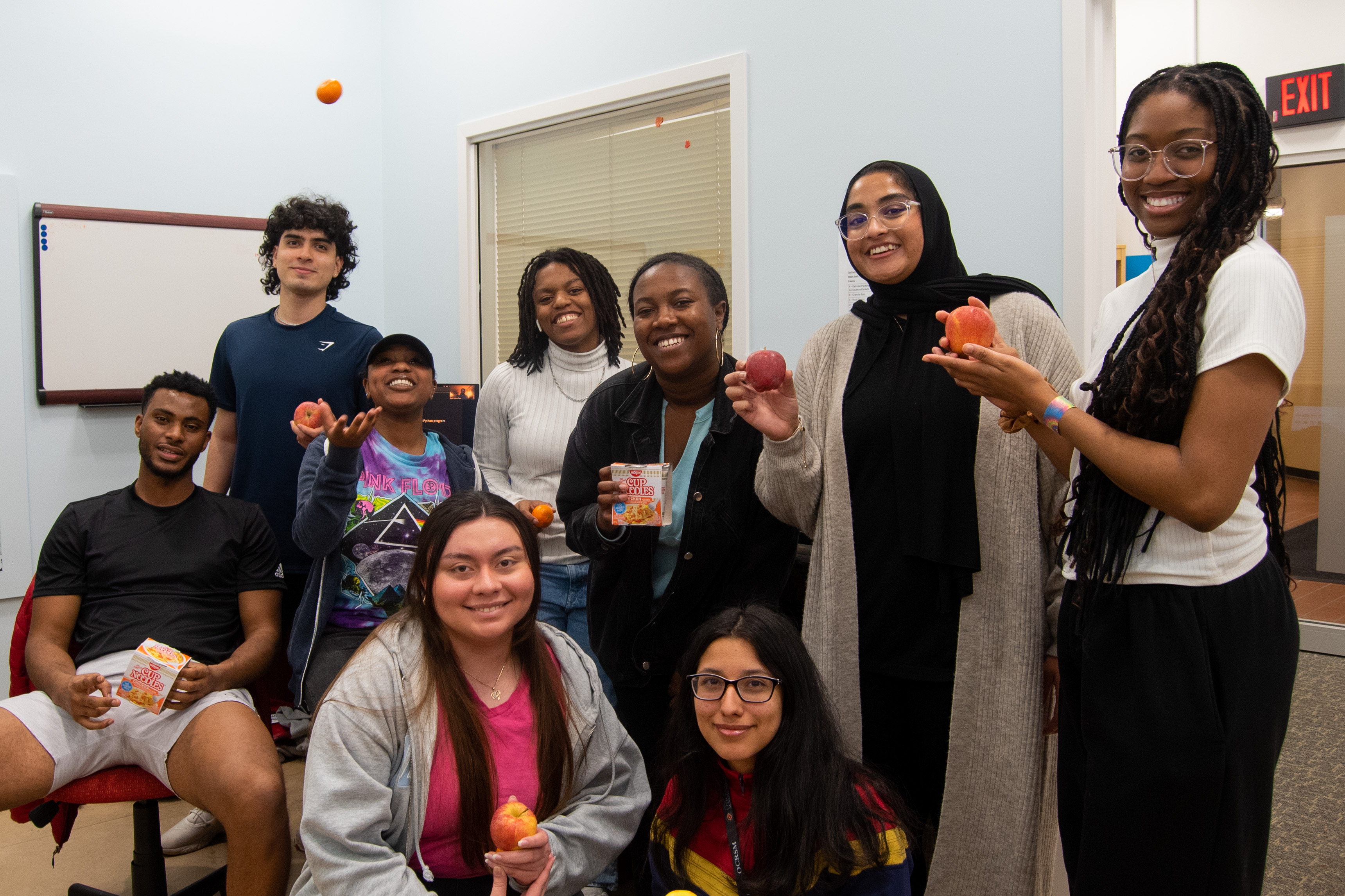 students hold fruits and snacks